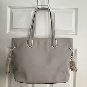 Grey Kate Spade bag with white stitching and zipper top